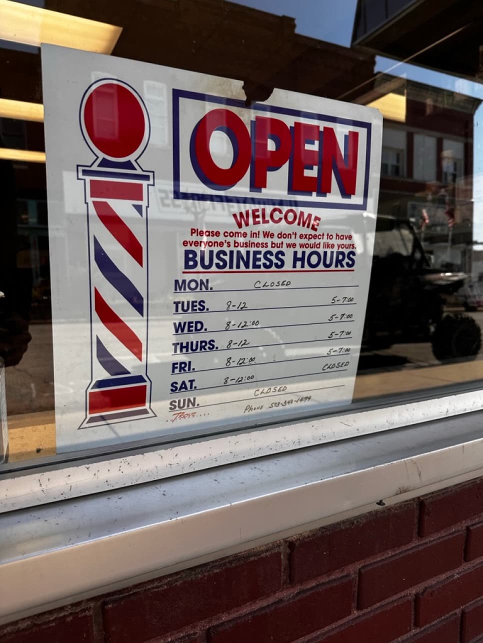 A photograph of the business hours sign.